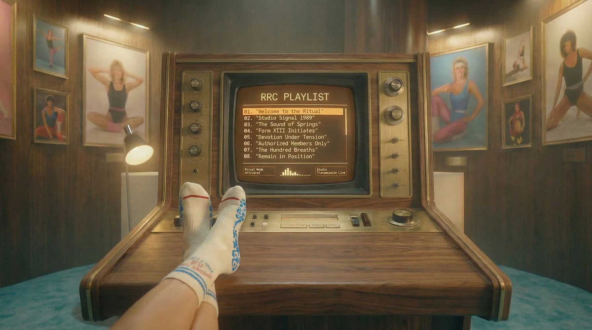 Vintage-style entertainment console with a screen displaying a 'RRC Playlist' in a room with framed pictures on the wall.